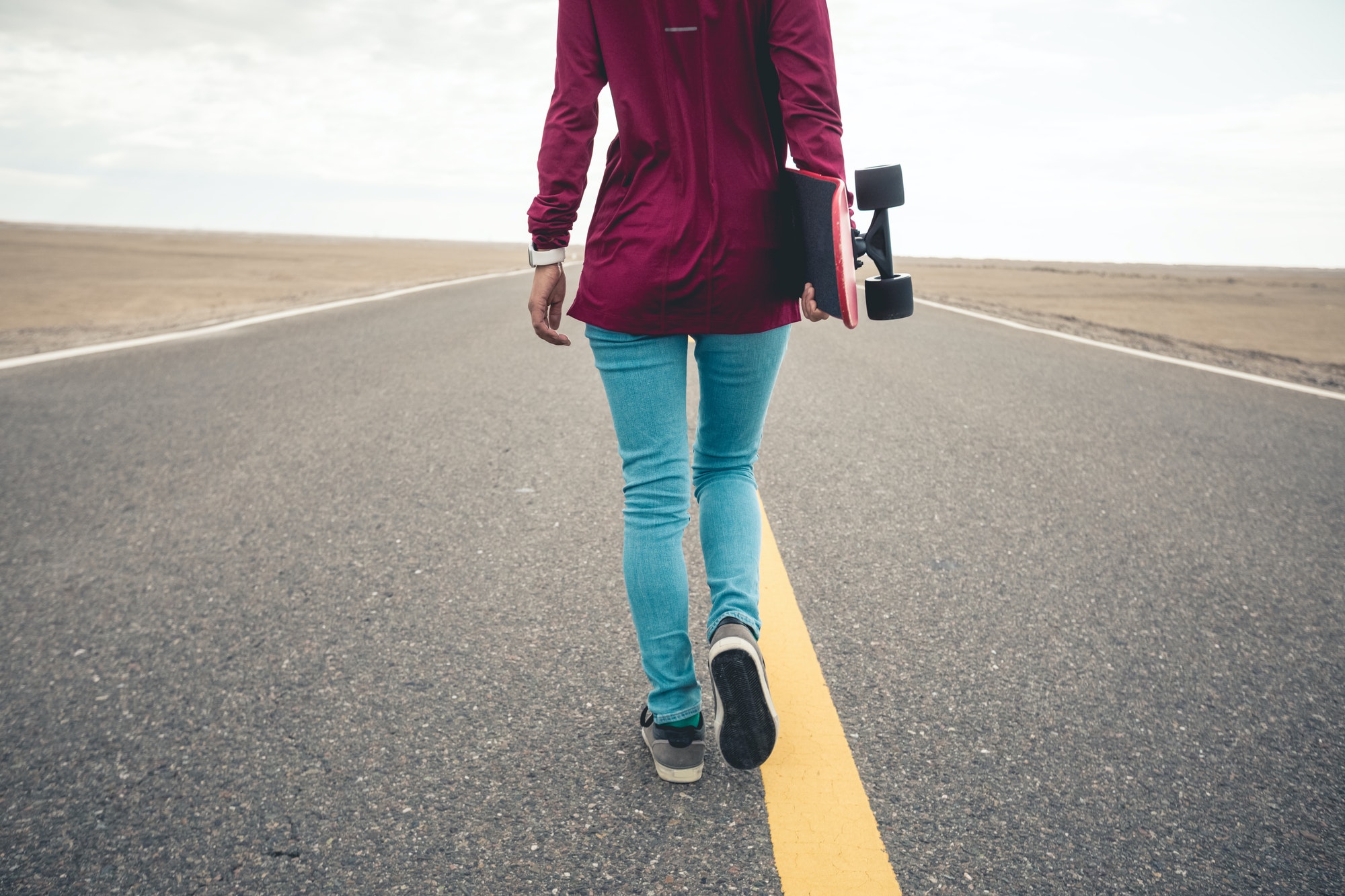 asian-woman-skateboarder-skateboarding-in-the-wide-world